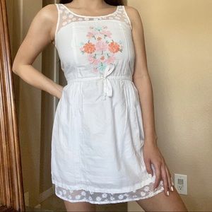 White mini dress w/ lace floral detailing, colorful embroidery & tie on waist